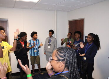 Group of students gathered together ina classroom.