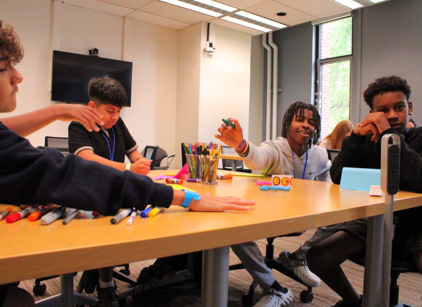 Group of students doing arts and crafts at a table.