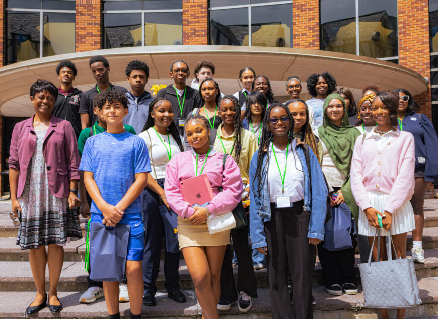 Group of students posing together for a group photo on campus.