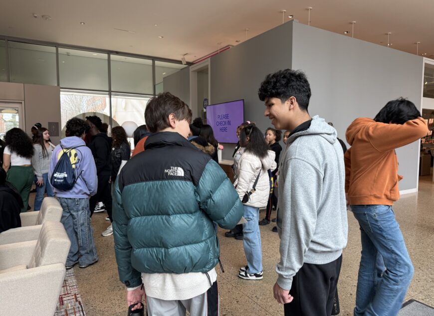 Group of students talking in the hallway.