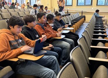 Group of students sitting together in an auditorium.