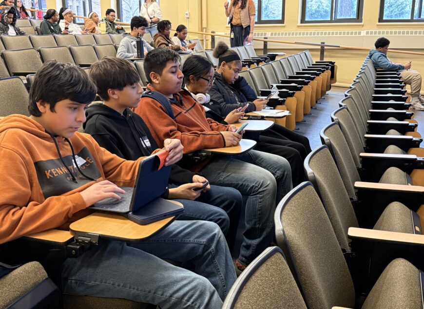 Group of students sitting together in an auditorium.