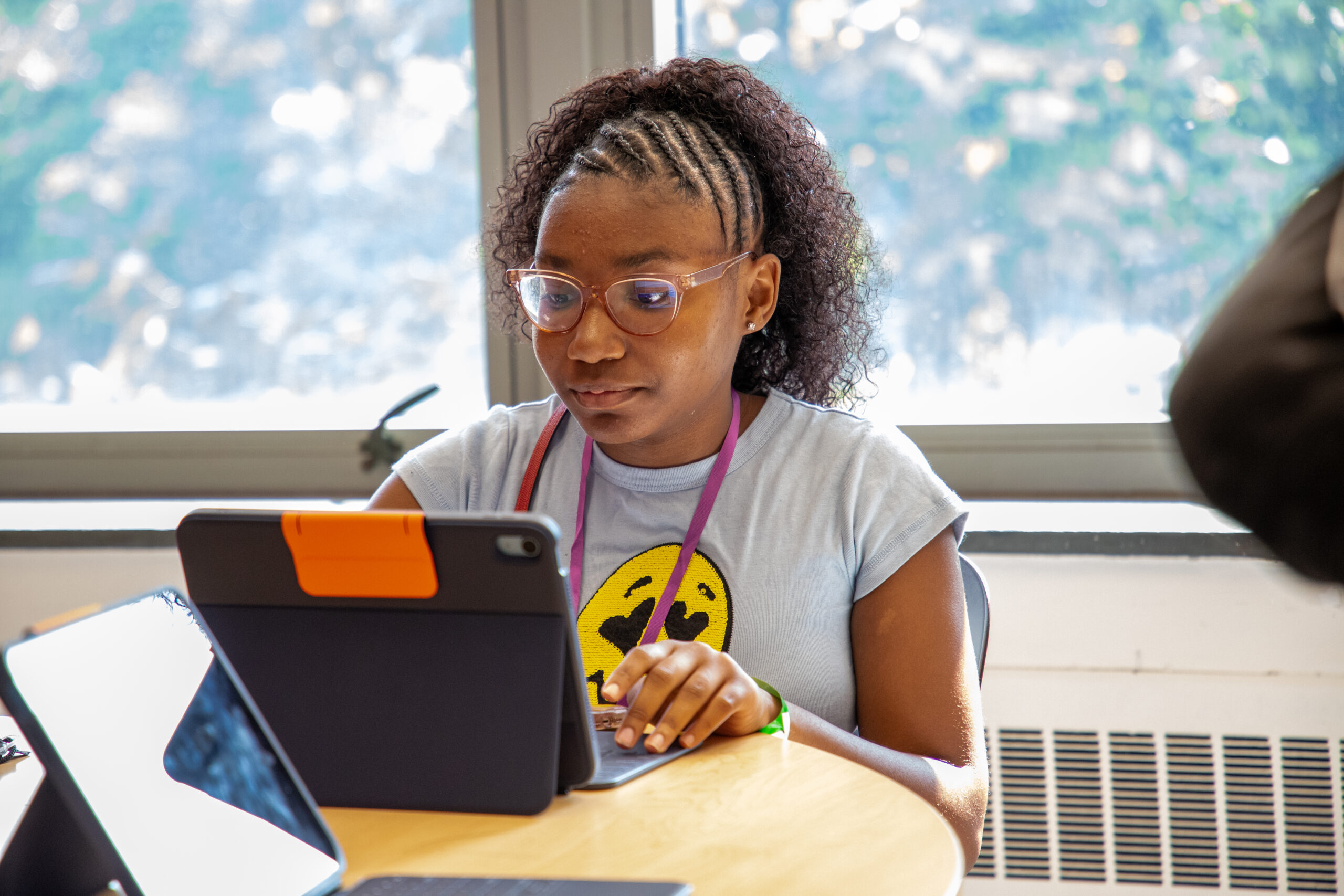 girl wearing glasses staring at ipad